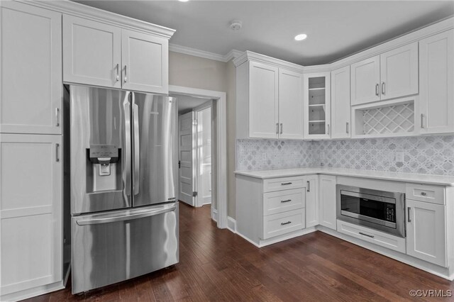 2920 Hawthorne Ave, Richmond, VA 23222 - kitchen featuring appliances with stainless steel finishes, light countertops, glass insert cabinets, dark wood finished floors, and white cabinetry