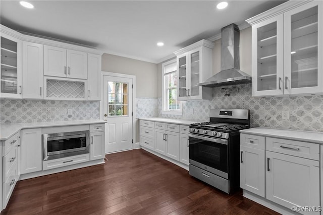 2920 Hawthorne Ave, Richmond, VA 23222 - kitchen featuring stainless steel appliances, wall chimney exhaust hood, light countertops, white cabinets, and recessed lighting