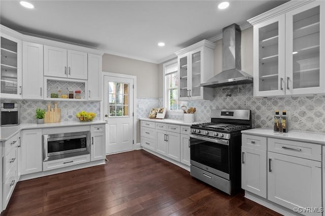 2920 Hawthorne Ave, Richmond, VA 23222 - kitchen featuring wall chimney exhaust hood, appliances with stainless steel finishes, light countertops, dark wood-style flooring, and recessed lighting