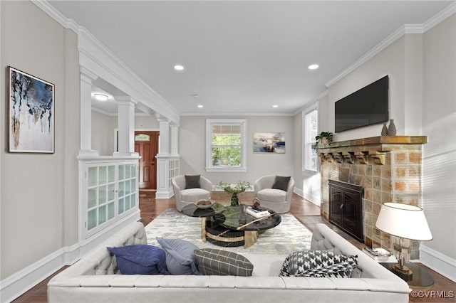 2920 Hawthorne Ave, Richmond, VA 23222 - living room featuring decorative columns, a tiled fireplace, baseboards, recessed lighting, and wood finished floors