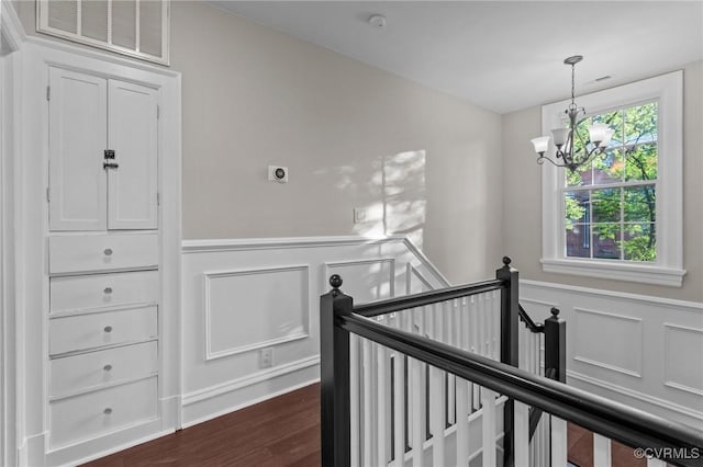 2920 Hawthorne Ave, Richmond, VA 23222 - hall with an upstairs landing, wainscoting, a chandelier, a decorative wall, and dark wood-style flooring