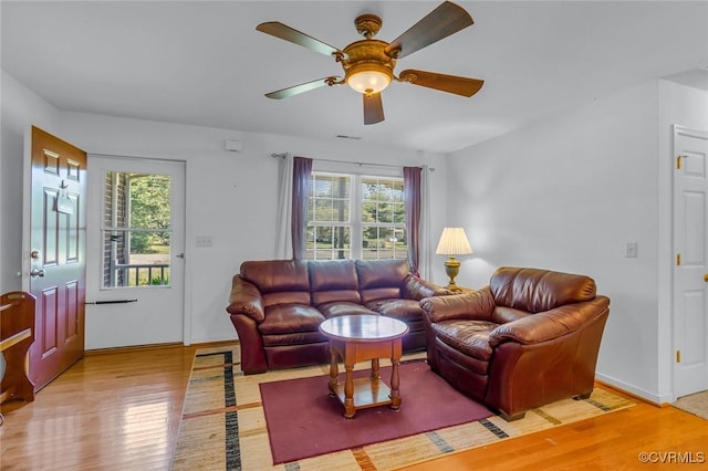 327 White Sand Dr, Heathsville, VA 22473 - living area featuring wood finished floors, healthy amount of natural light, a ceiling fan, and baseboards