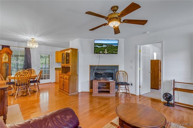327 White Sand Dr, Heathsville, VA 22473 - living room with light wood-style floors, a chandelier, a ceiling fan, and baseboards