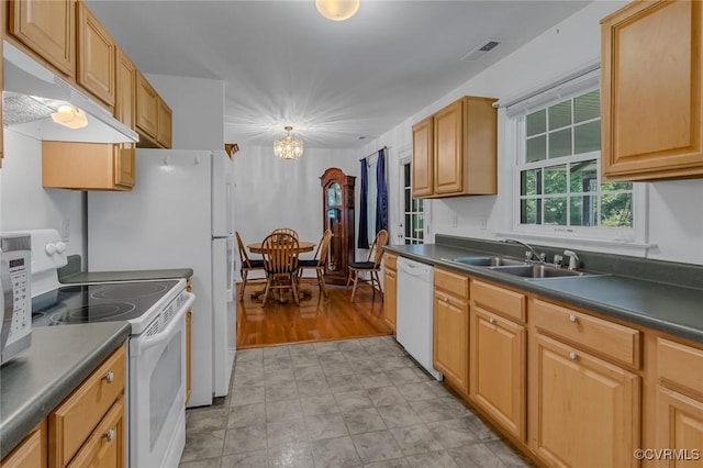327 White Sand Dr, Heathsville, VA 22473 - kitchen with white appliances, a sink, under cabinet range hood, dark countertops, and a chandelier