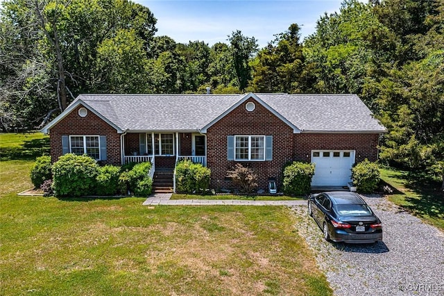 327 White Sand Dr, Heathsville, VA 22473 - ranch-style home featuring a porch, brick siding, a front lawn, and an attached garage