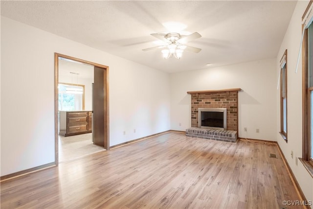 13100 Spring Trace Pl, Midlothian, VA 23112 - unfurnished living room with light wood finished floors, a ceiling fan, and a brick fireplace