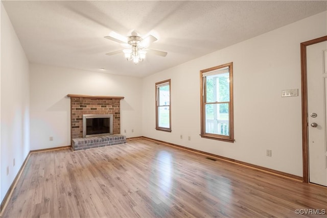 13100 Spring Trace Pl, Midlothian, VA 23112 - unfurnished living room with ceiling fan, wood finished floors, and a brick fireplace