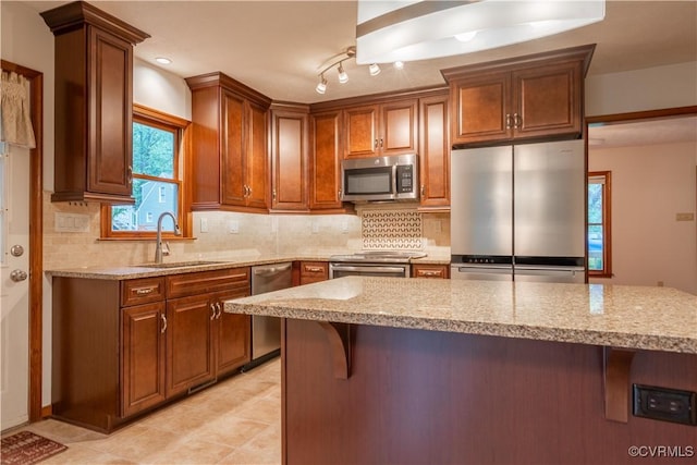 13100 Spring Trace Pl, Midlothian, VA 23112 - kitchen with appliances with stainless steel finishes, light stone counters, a breakfast bar area, and backsplash