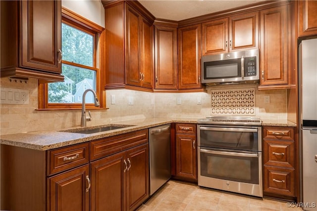 13100 Spring Trace Pl, Midlothian, VA 23112 - kitchen with stainless steel appliances, light stone counters, backsplash, and brown cabinets