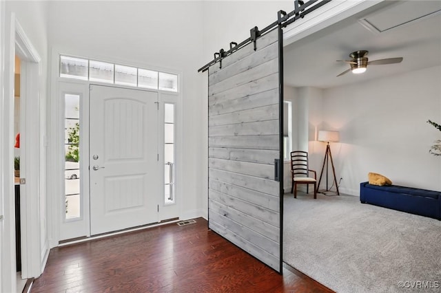 17912 Pine Canyon Trl, Moseley, VA 23120 - foyer featuring dark wood-type flooring, baseboards, plenty of natural light, a barn door, and a high ceiling