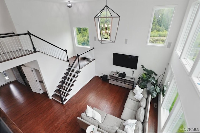 17912 Pine Canyon Trl, Moseley, VA 23120 - living room with wood finished floors, healthy amount of natural light, a chandelier, a high ceiling, and baseboards