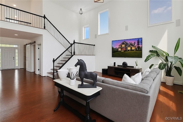 17912 Pine Canyon Trl, Moseley, VA 23120 - living area featuring a high ceiling, wood finished floors, stairs, healthy amount of natural light, and baseboards
