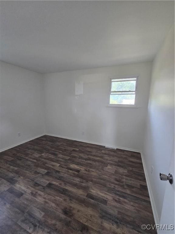 4811 Altair Rd, Henrico, VA 23231 - spare room with baseboards and dark wood-type flooring