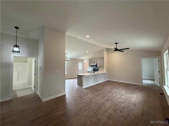 008 Barefords Mill Rd, Dunnsville, VA 22454 - unfurnished living room with lofted ceiling, a ceiling fan, dark wood-style floors, and baseboards