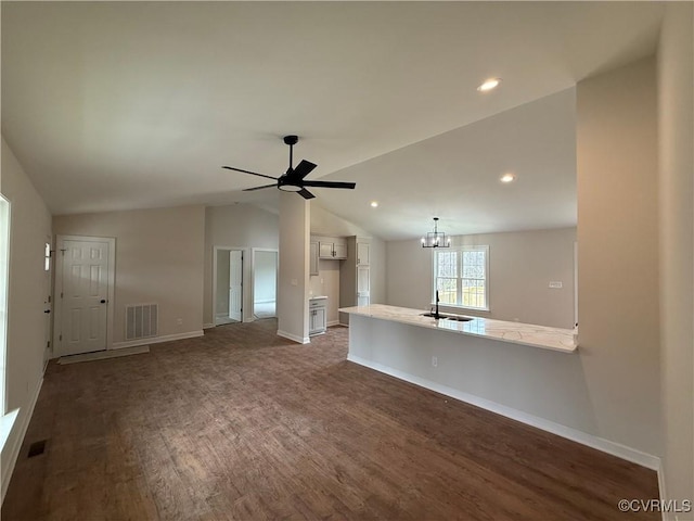 008 Barefords Mill Rd, Dunnsville, VA 22454 - unfurnished living room with a sink, wood finished floors, vaulted ceiling, a chandelier, and ceiling fan