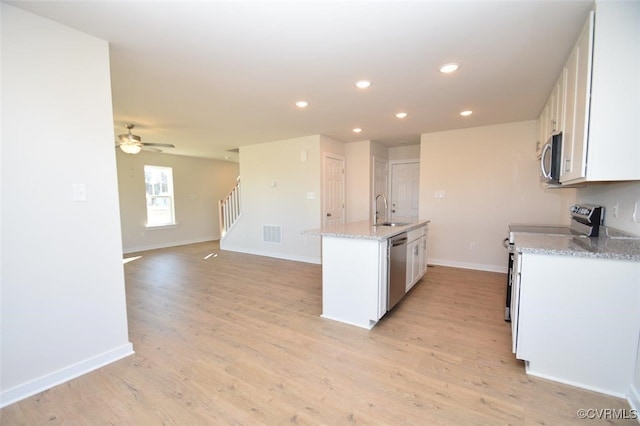 2628 Butterbean Ct, Richmond, VA 23231 - kitchen featuring stainless steel appliances, a sink, white cabinets, recessed lighting, and a center island with sink