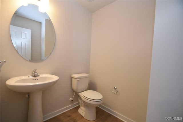 2628 Butterbean Ct, Richmond, VA 23231 - half bath featuring wood finished floors, toilet, baseboards, and a sink