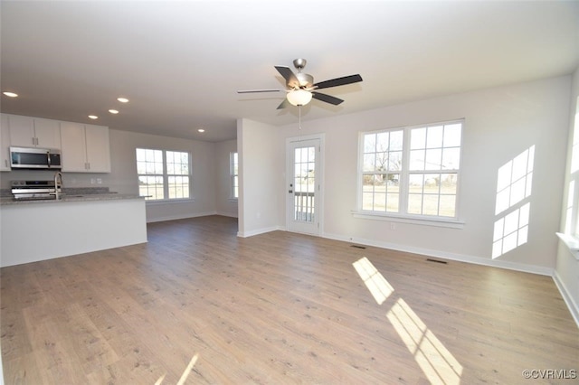 2628 Butterbean Ct, Richmond, VA 23231 - unfurnished living room featuring ceiling fan, recessed lighting, baseboards, and light wood-style floors