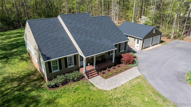 20031 Woodland Fox Ln, Rockville, VA 23146 - view of front of house featuring covered porch, an outdoor structure, a front yard, roof with shingles, and a detached garage
