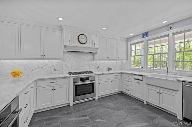 20031 Woodland Fox Ln, Rockville, VA 23146 - kitchen featuring appliances with stainless steel finishes, a sink, white cabinets, custom exhaust hood, and recessed lighting