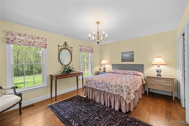 20031 Woodland Fox Ln, Rockville, VA 23146 - bedroom with a chandelier, wood finished floors, and baseboards