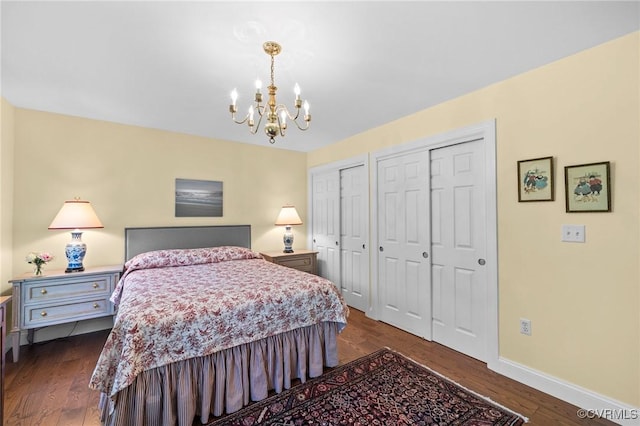 20031 Woodland Fox Ln, Rockville, VA 23146 - bedroom with multiple closets, a chandelier, dark wood-type flooring, and baseboards