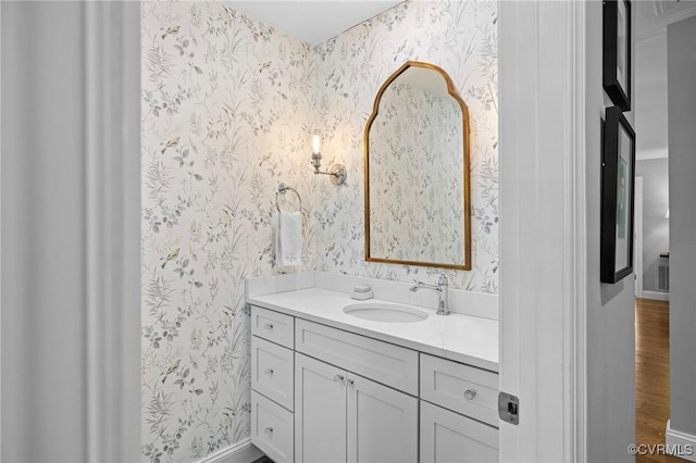 20031 Woodland Fox Ln, Rockville, VA 23146 - bathroom featuring wallpapered walls, vanity, baseboards, and wood finished floors
