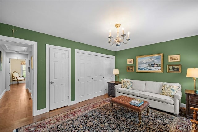 20031 Woodland Fox Ln, Rockville, VA 23146 - living room with attic access, wood finished floors, baseboards, and a chandelier