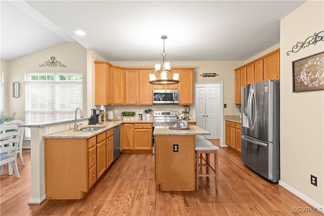 8412 Newbys Mill Dr, Chesterfield, VA 23832 - kitchen with stainless steel appliances, a breakfast bar, light wood-type flooring, a peninsula, and vaulted ceiling
