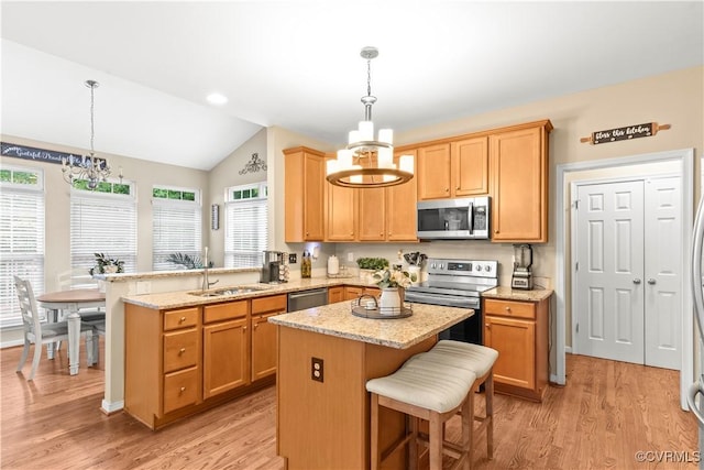 8412 Newbys Mill Dr, Chesterfield, VA 23832 - kitchen with stainless steel appliances, a chandelier, a peninsula, vaulted ceiling, and light wood-style flooring