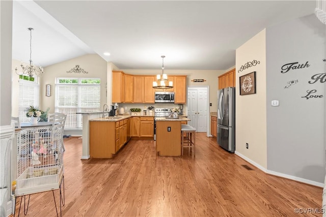 8412 Newbys Mill Dr, Chesterfield, VA 23832 - kitchen featuring a chandelier, appliances with stainless steel finishes, a breakfast bar, a peninsula, and lofted ceiling