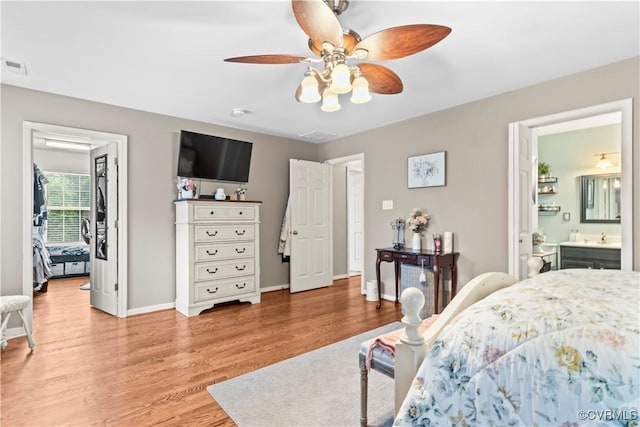 8412 Newbys Mill Dr, Chesterfield, VA 23832 - bedroom with light wood-style floors, a walk in closet, a ceiling fan, and connected bathroom