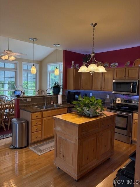 11292 Silverstone Dr, Mechanicsville, VA 23116 - kitchen with stainless steel appliances, a sink, light wood-style floors, ceiling fan, and vaulted ceiling