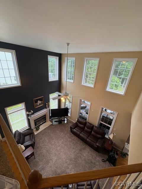 11292 Silverstone Dr, Mechanicsville, VA 23116 - carpeted living area featuring plenty of natural light, a fireplace with flush hearth, and a ceiling fan