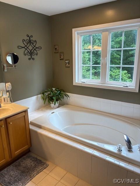 11292 Silverstone Dr, Mechanicsville, VA 23116 - bathroom featuring vanity, plenty of natural light, a garden tub, and tile patterned floors