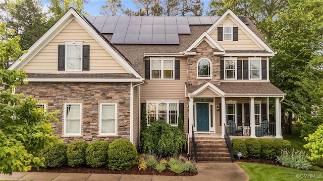 8324 Longlands Pl, Chesterfield, VA 23832 - view of front facade with covered porch, stone siding, solar panels, and a shingled roof