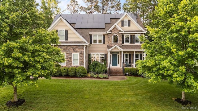 8324 Longlands Pl, Chesterfield, VA 23832 - view of front of house featuring stone siding, a front yard, roof mounted solar panels, a shingled roof, and a porch