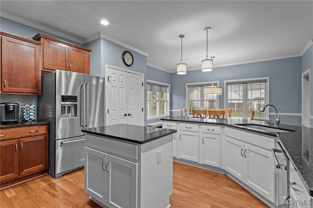 8324 Longlands Pl, Chesterfield, VA 23832 - kitchen with high end fridge, a sink, ornamental molding, light wood finished floors, and decorative light fixtures