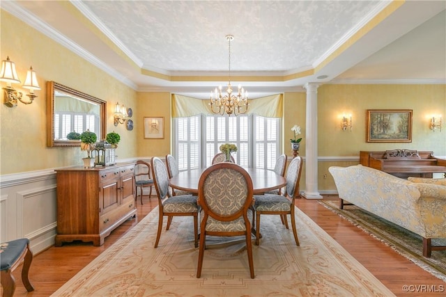 522 Hunt Field Rd, Manakin Sabot, VA 23103 - dining space featuring a chandelier, light wood-type flooring, a tray ceiling, crown molding, and ornate columns