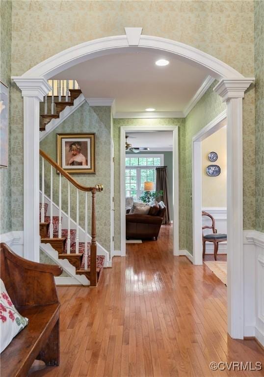522 Hunt Field Rd, Manakin Sabot, VA 23103 - foyer entrance with wallpapered walls, arched walkways, crown molding, wood-type flooring, and stairs