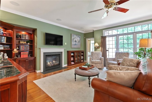522 Hunt Field Rd, Manakin Sabot, VA 23103 - living area featuring a ceiling fan, ornamental molding, a fireplace with flush hearth, light wood finished floors, and baseboards