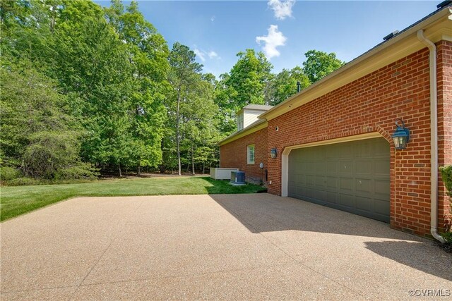 522 Hunt Field Rd, Manakin Sabot, VA 23103 - view of home's exterior with brick siding, concrete driveway, an attached garage, central air condition unit, and a lawn