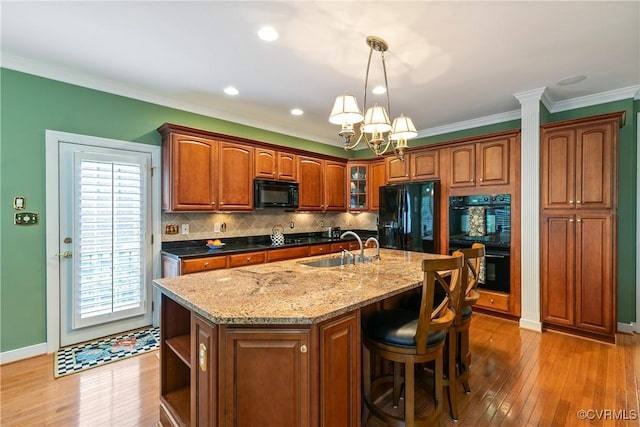 522 Hunt Field Rd, Manakin Sabot, VA 23103 - kitchen with black appliances, a sink, a chandelier, light wood finished floors, and crown molding