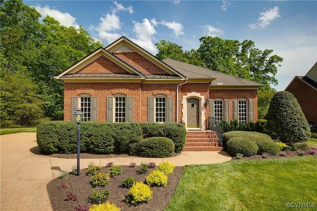 522 Hunt Field Rd, Manakin Sabot, VA 23103 - georgian-style home featuring brick siding, a front lawn, and a standing seam roof