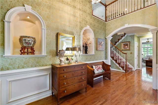522 Hunt Field Rd, Manakin Sabot, VA 23103 - entryway featuring wallpapered walls, wood-type flooring, stairway, wainscoting, and arched walkways