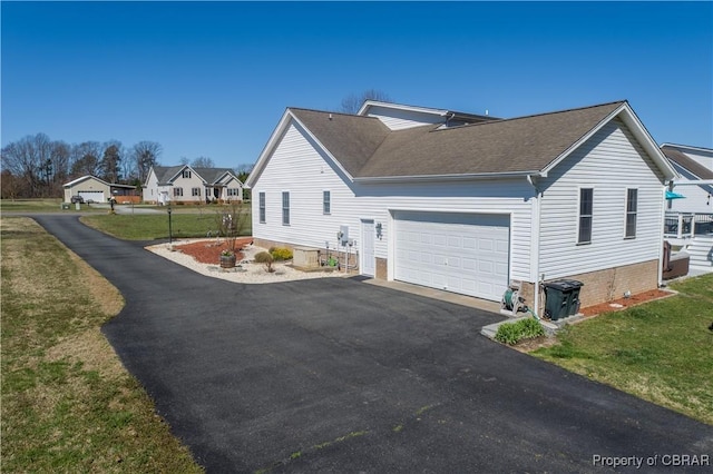 274 Meadow Dr, Tappahannock, VA 22560 - view of side of property featuring driveway, a shingled roof, a lawn, and an attached garage