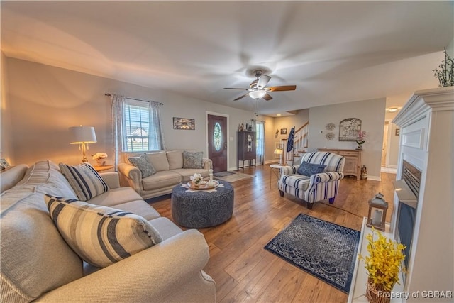 274 Meadow Dr, Tappahannock, VA 22560 - living room featuring stairs, wood-type flooring, a ceiling fan, baseboards, and a fireplace with flush hearth