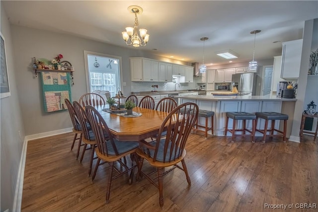 274 Meadow Dr, Tappahannock, VA 22560 - dining space featuring dark wood-style floors, a chandelier, and baseboards