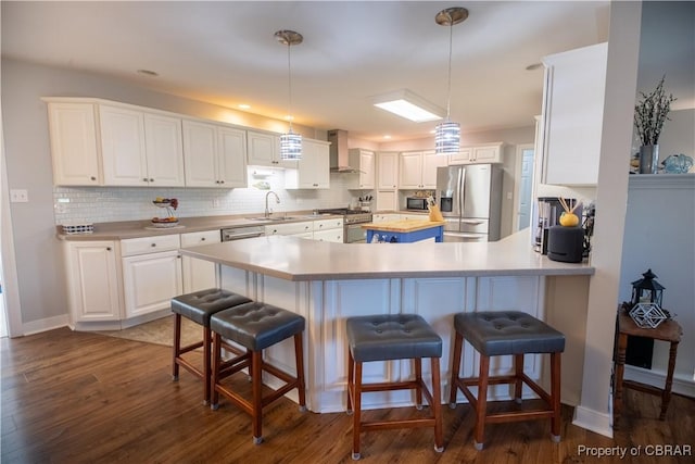 274 Meadow Dr, Tappahannock, VA 22560 - kitchen featuring appliances with stainless steel finishes, wall chimney exhaust hood, white cabinetry, and dark wood-style flooring