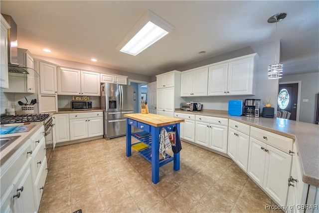 274 Meadow Dr, Tappahannock, VA 22560 - kitchen with stainless steel appliances, tasteful backsplash, wall chimney exhaust hood, white cabinetry, and recessed lighting